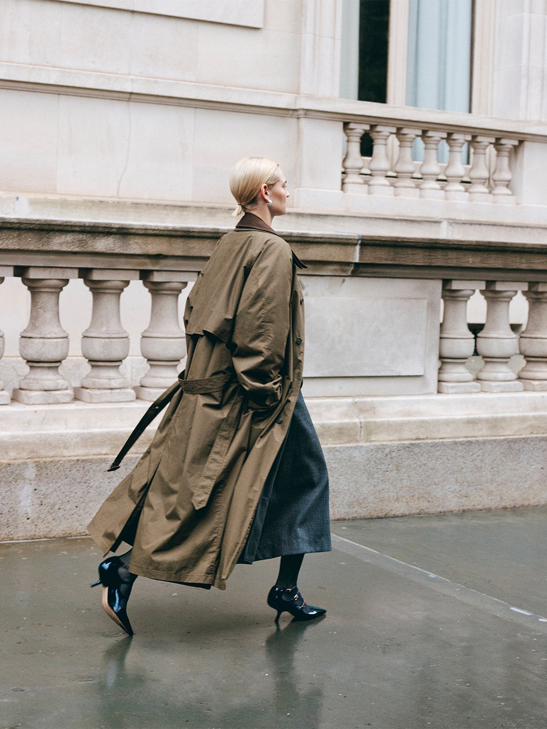 Side view of a black leather mary jane heels with adjustable straps and a pointed toe, shown on a model.