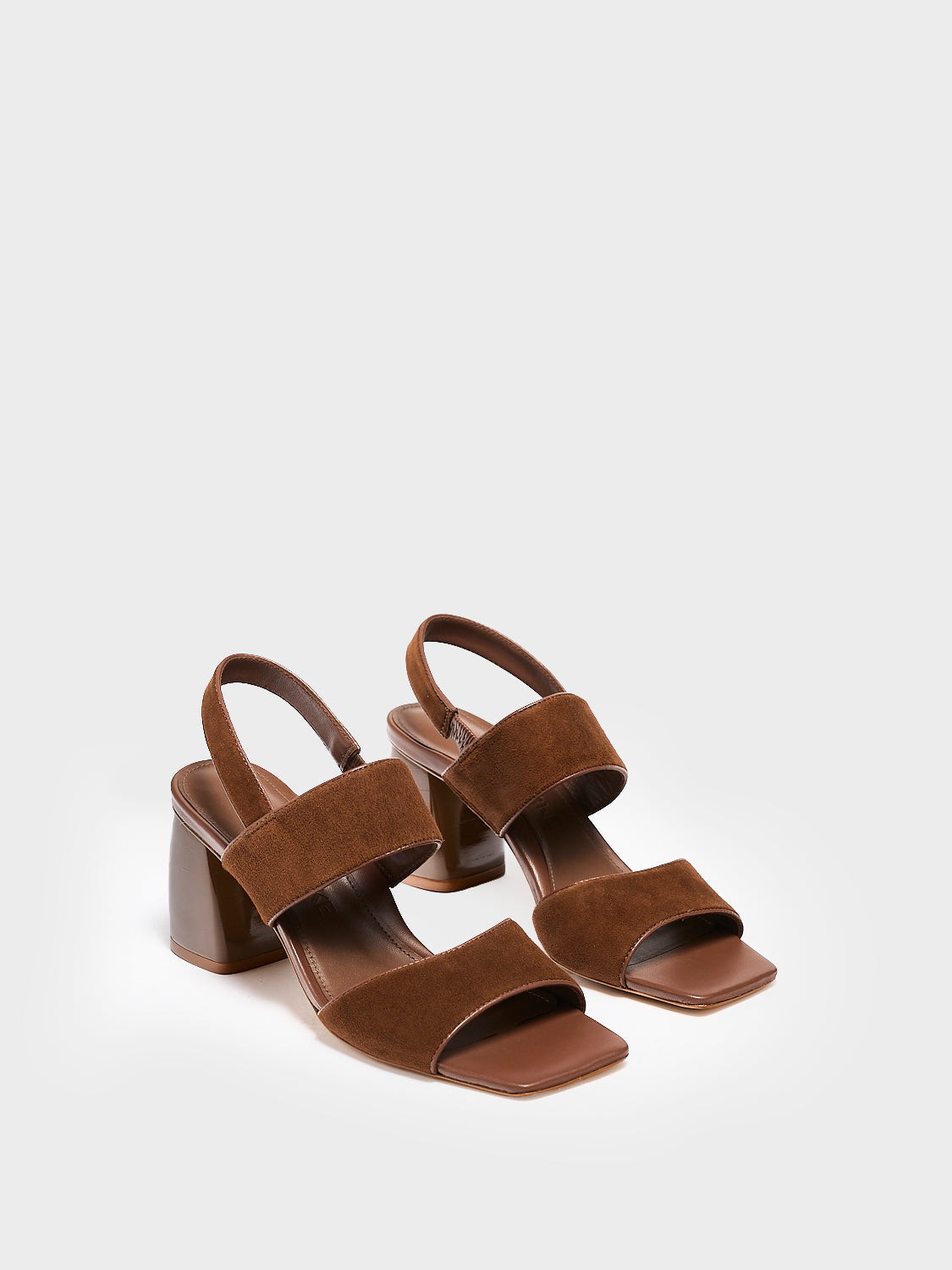 Angle view of a pair of mocha brown suede block heel sandals with two over the foot straps and a square toe.