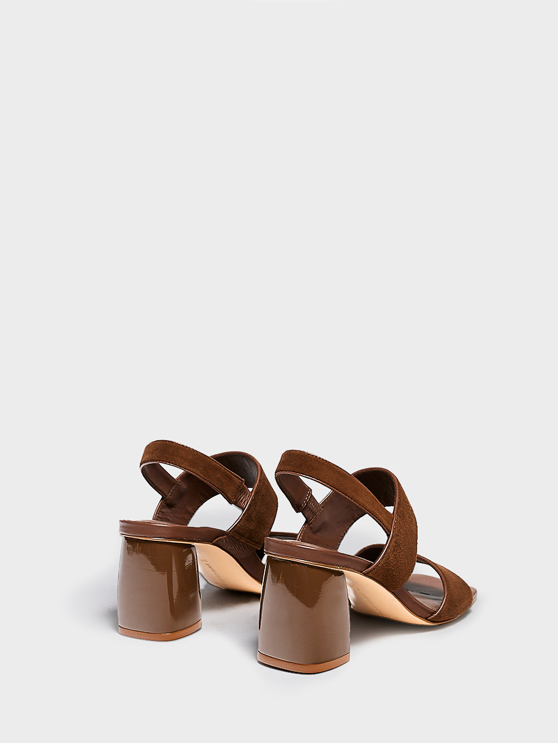 Back view of a pair of mocha brown suede block heel sandals with two over the foot straps and a square toe.