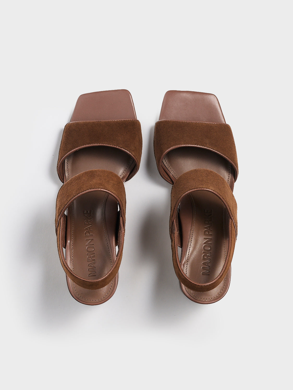 Top view of a pair of mocha brown suede block heel sandals with two over the foot straps and a square toe.