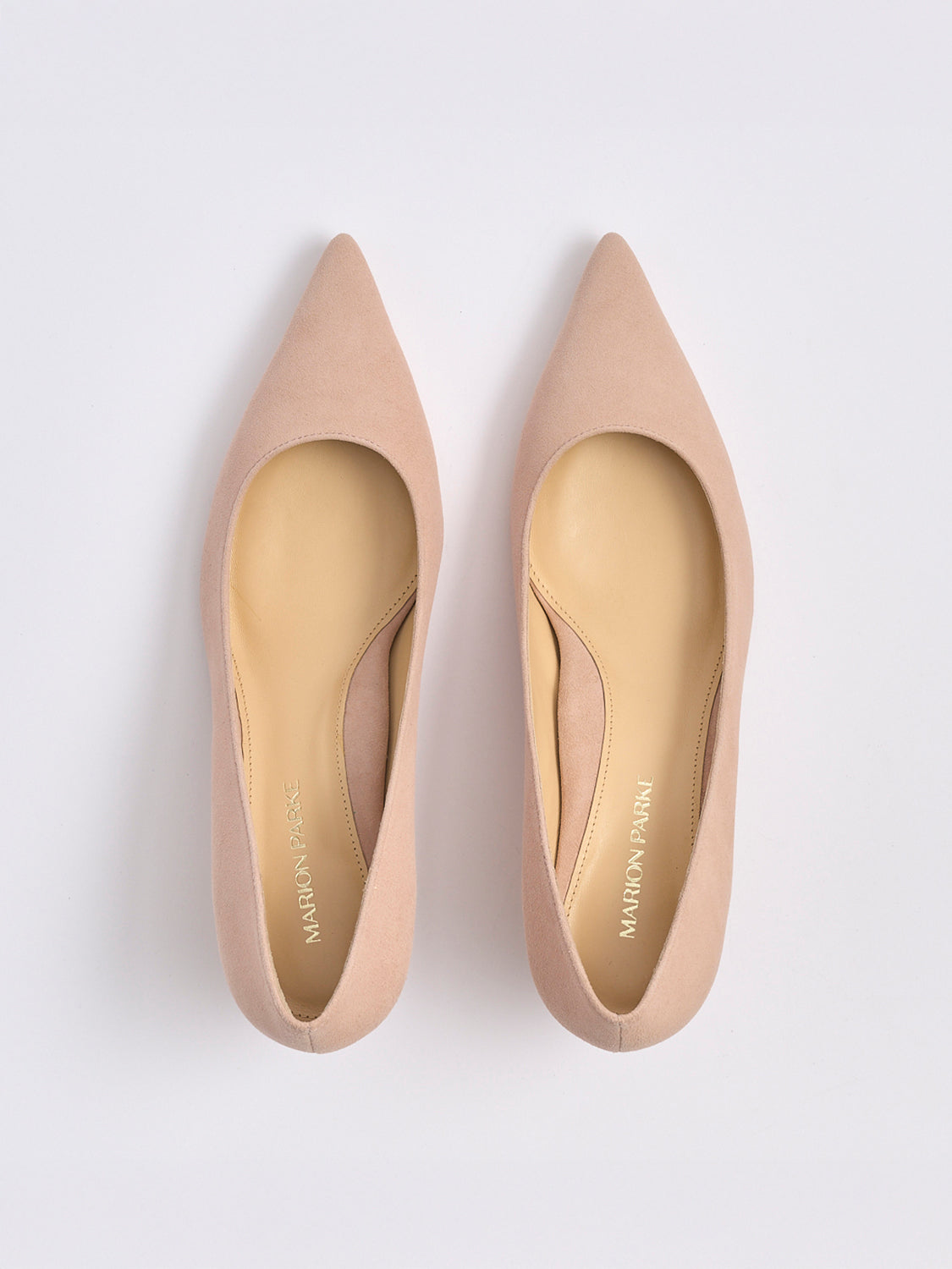 Top view of a pair of powder suede kitten stiletto heel pumps with a pointed toe.