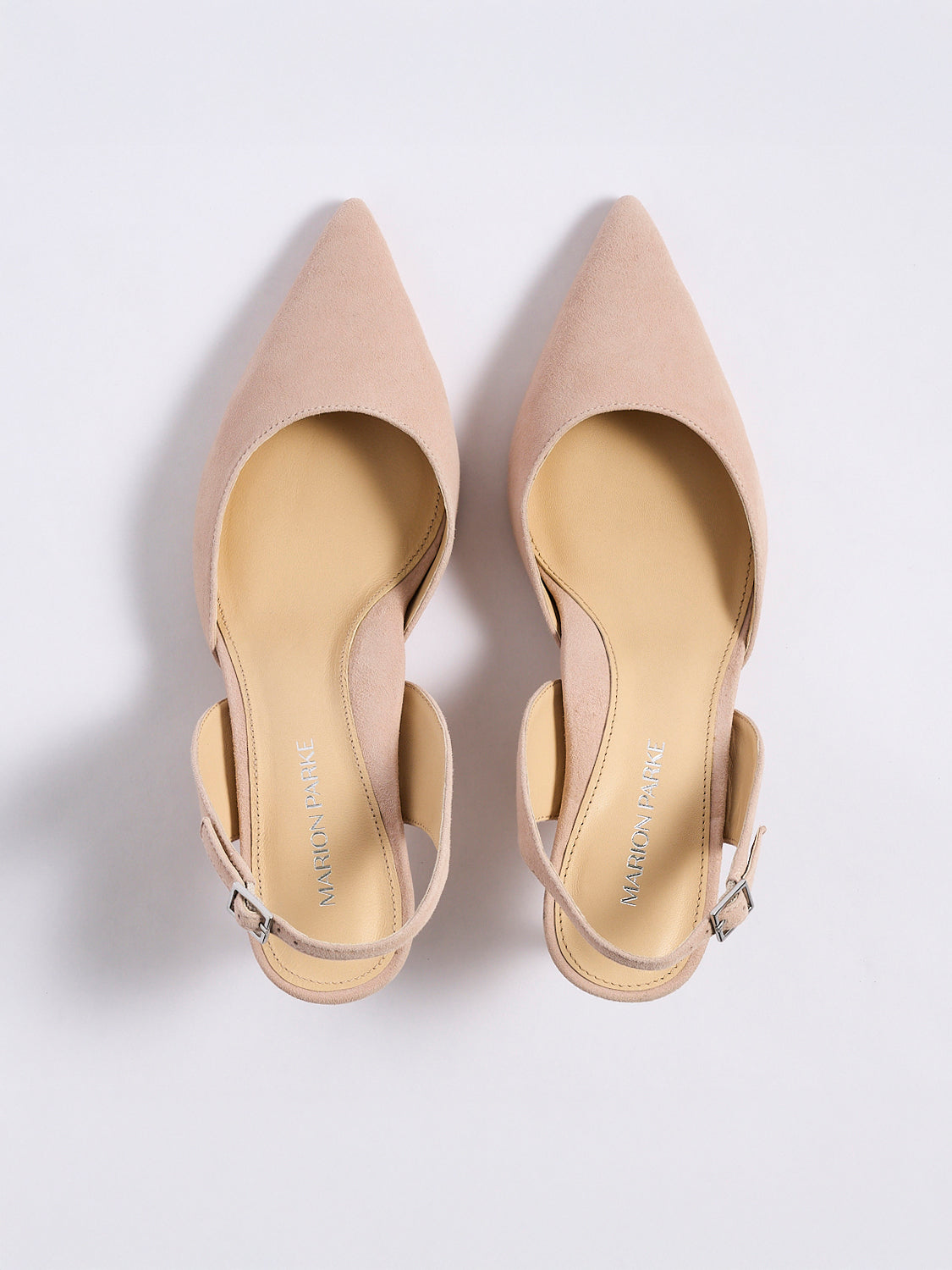 Top view of a pair of powder suede slingback heels with a pointed toe.