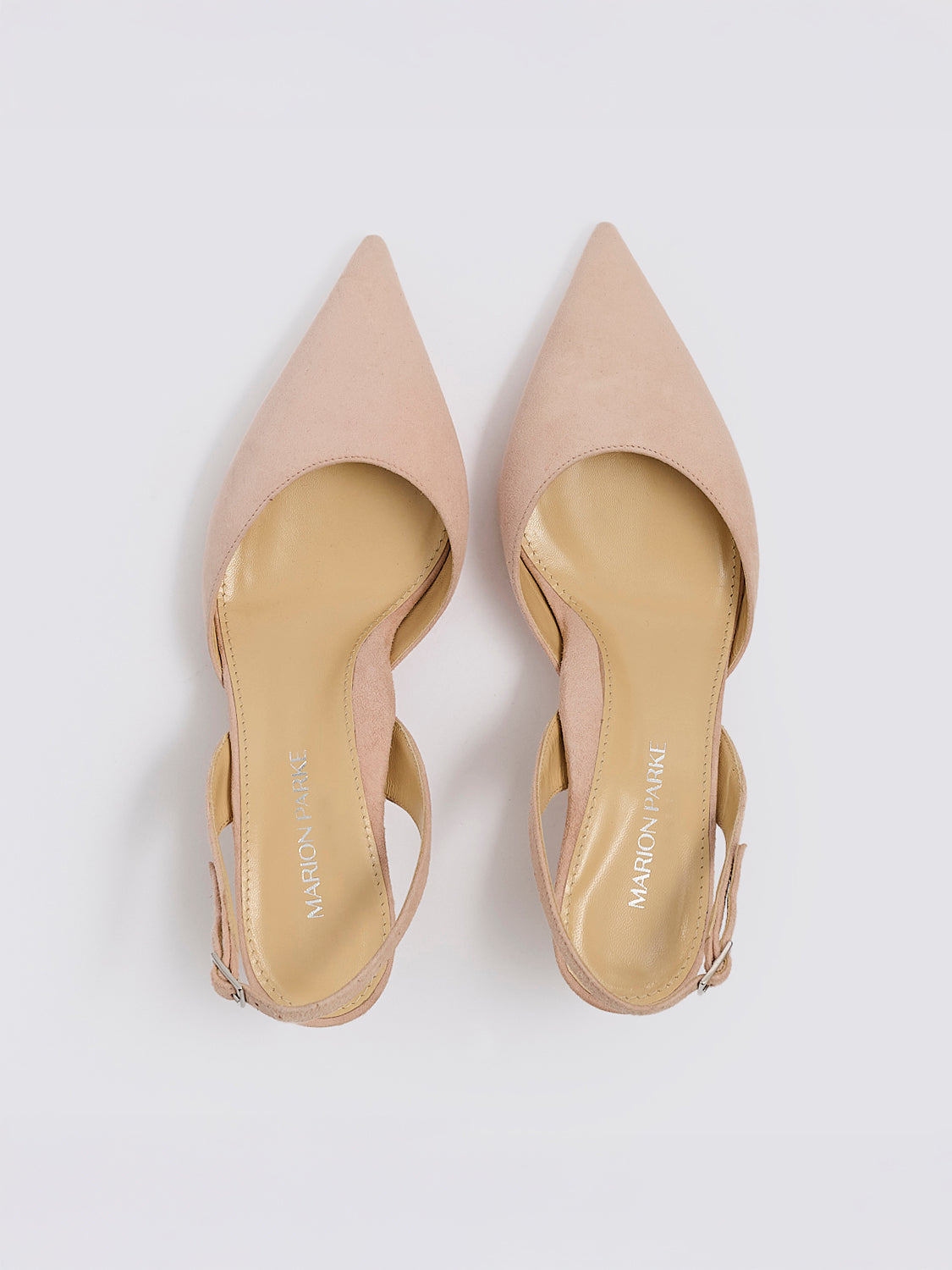 Top view of a pair of powder suede slingback kitten heels with a pointed toe