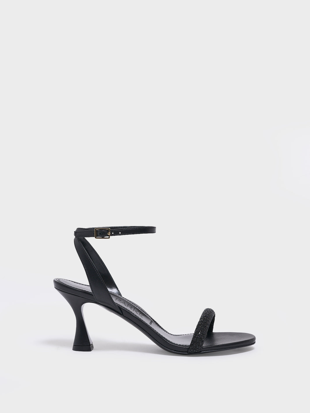 Profile view of an black leather high heel sandal with a crystal embellished toe strap and adjustable ankle strap.