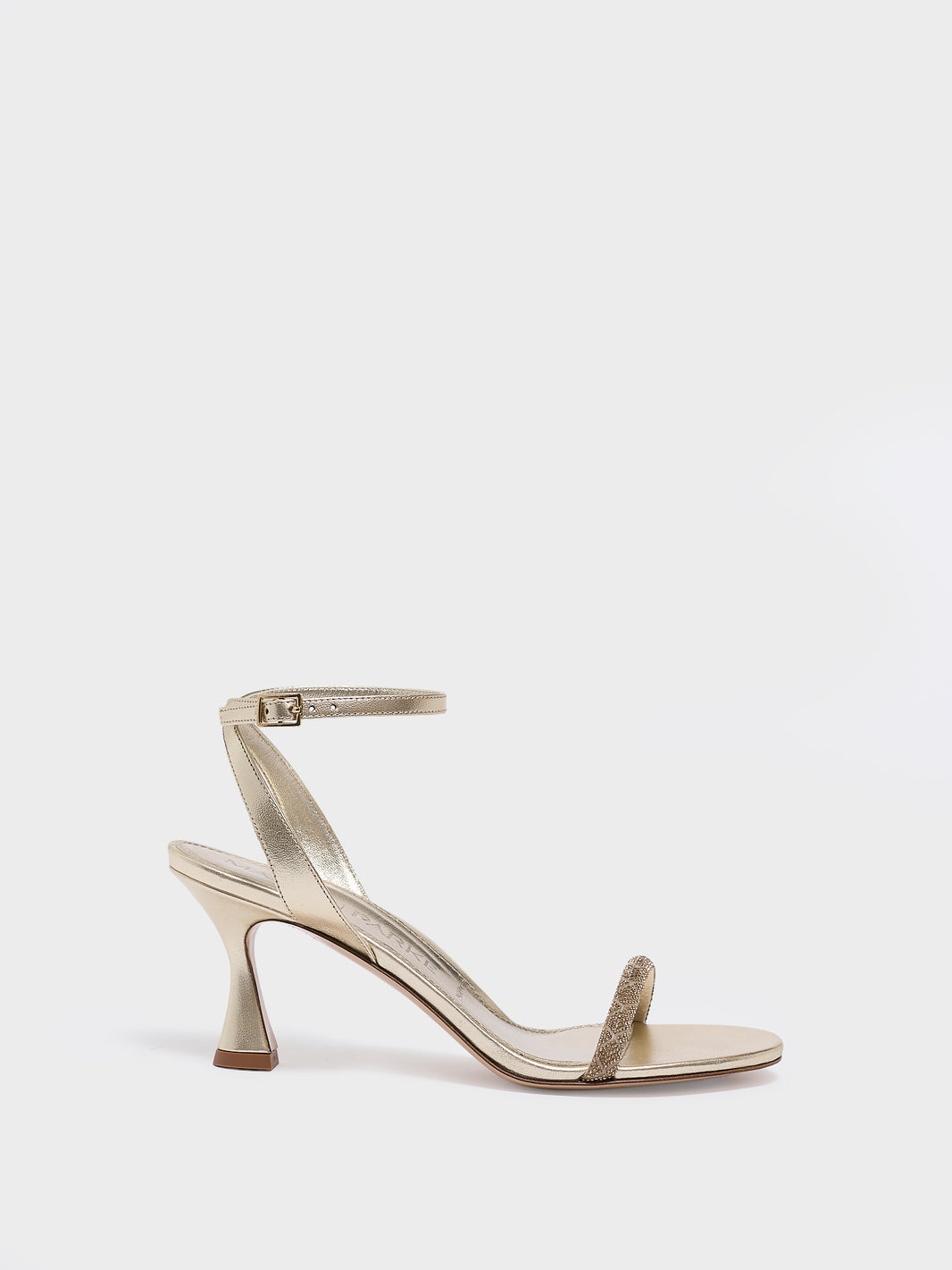 Profile view of an gold metallic leather high heel sandal with a crystal embellished toe strap and adjustable ankle strap.