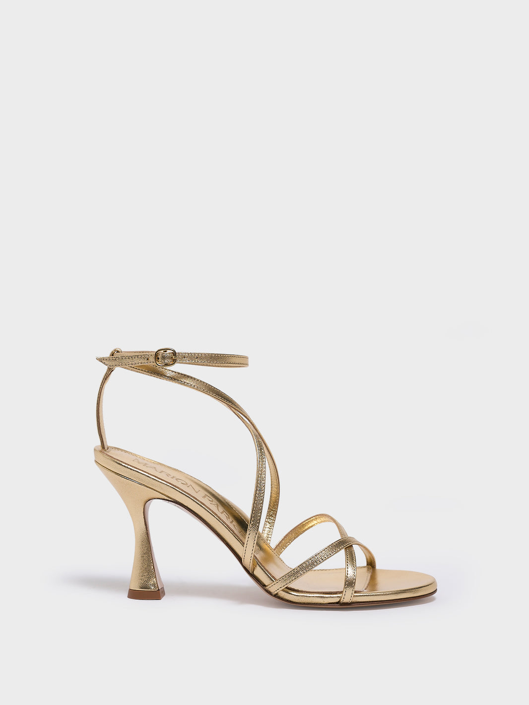 Profile view of a black leather high heel strappy sandal with an ankle strap detail.
