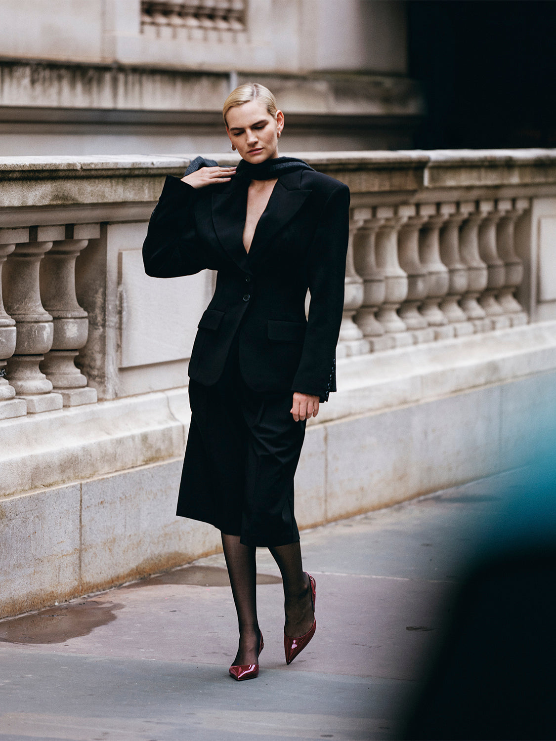 Front view of merlot red patent leather slingback heels with a pointed toe, shown on model.