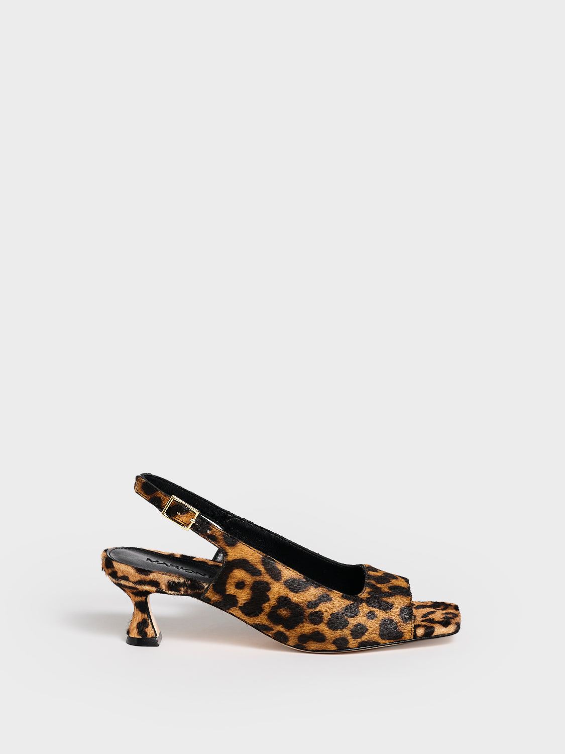 Profile view of a leopard hair calf slingback sandal with a flared kitten heel and square toe detail.