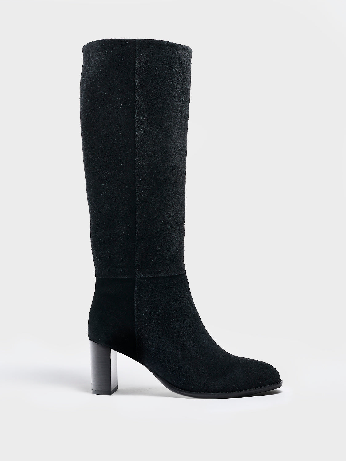 Profile view of a black suede scrunch tall boot with a block heel and round toe.