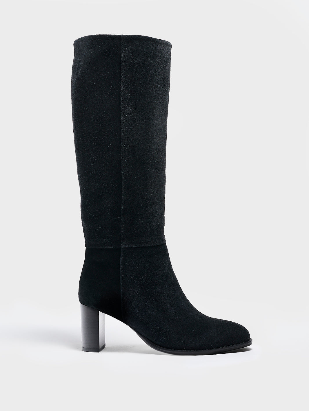 Profile view of a black suede scrunch tall boot with a block heel and round toe.
