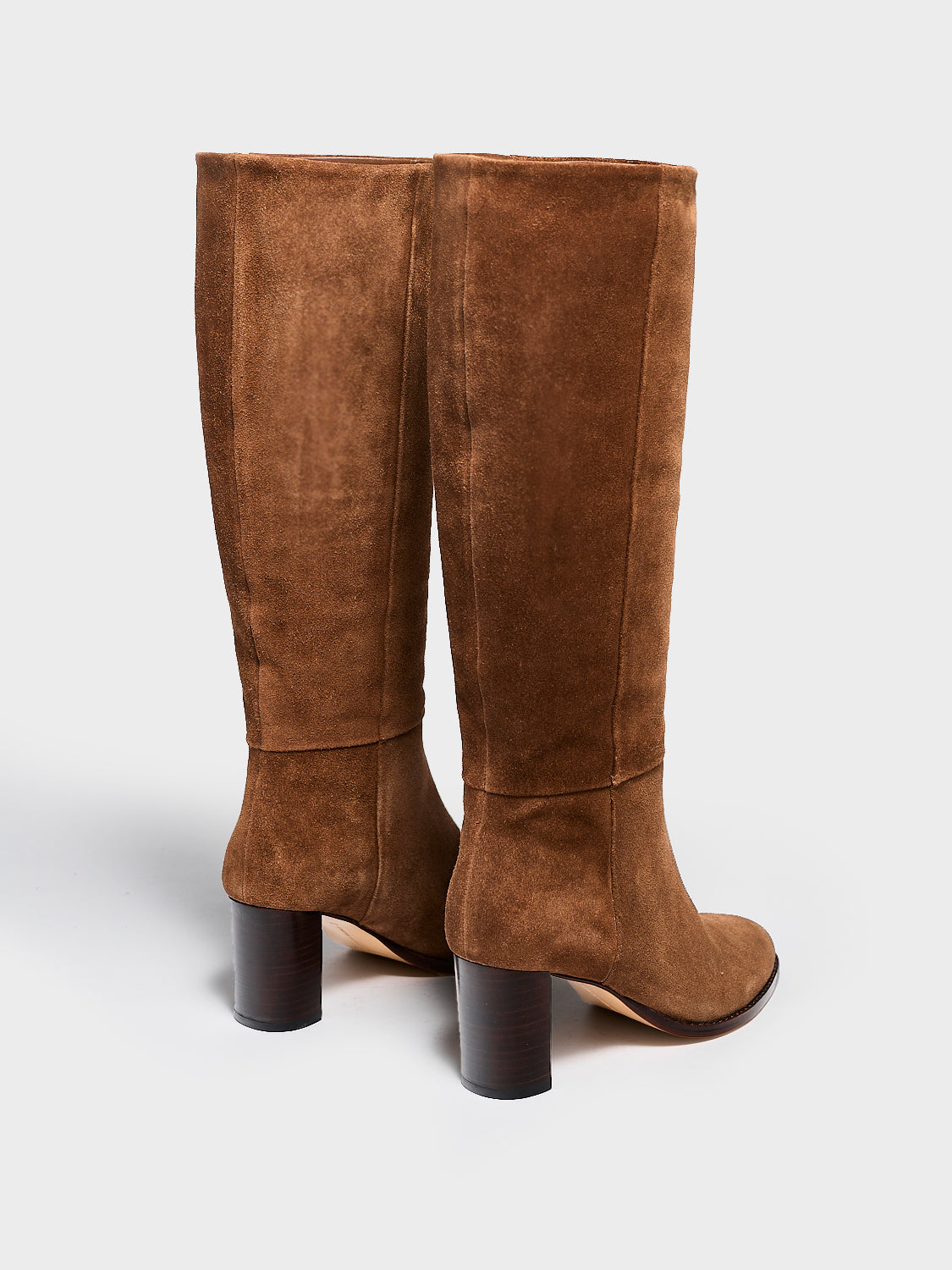 Back view of a pair of mocha brown suede scrunch tall boot with a block heel and round toe.