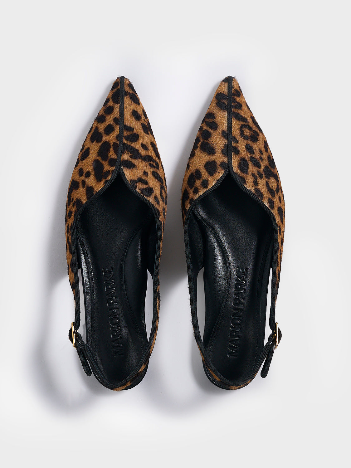 Top view of a pair of leopard hair calf slingback flats with a grosgrain trim detail.