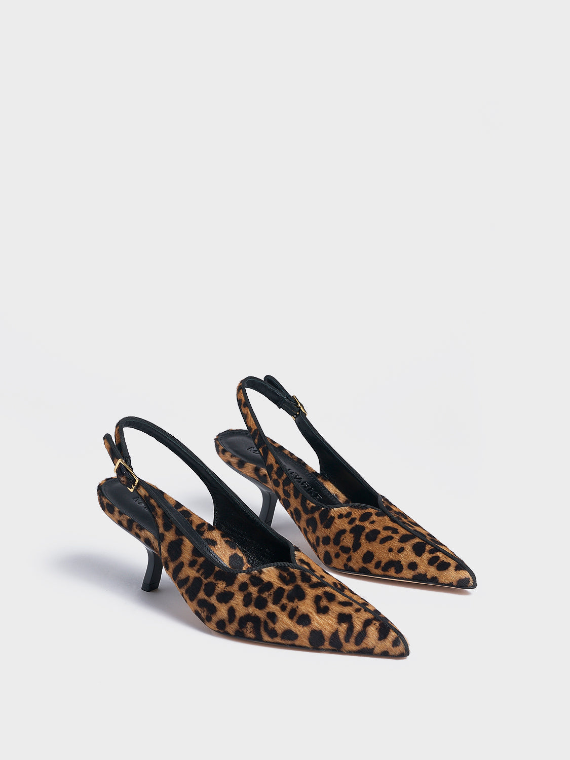 Angle view of a pair of leopard hair calf slingback kitten heels with a grosgrain trim and angled heel detail.