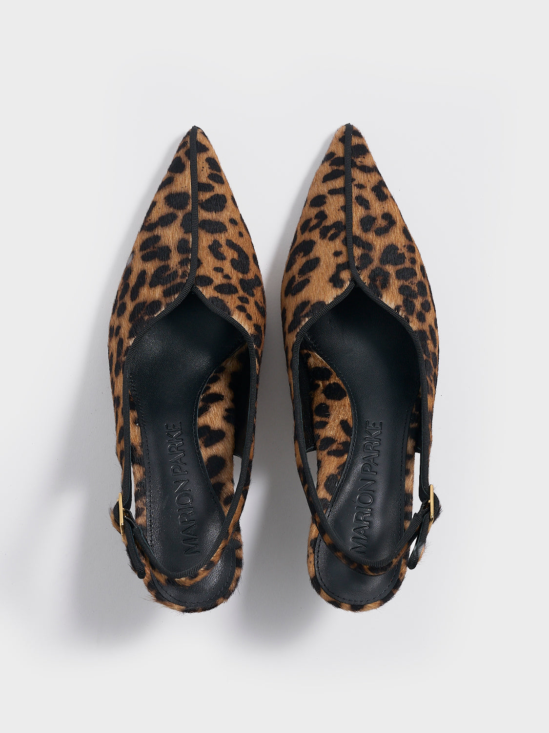 Top view of a pair of leopard hair calf slingback kitten heels with a grosgrain trim and angled heel detail.
