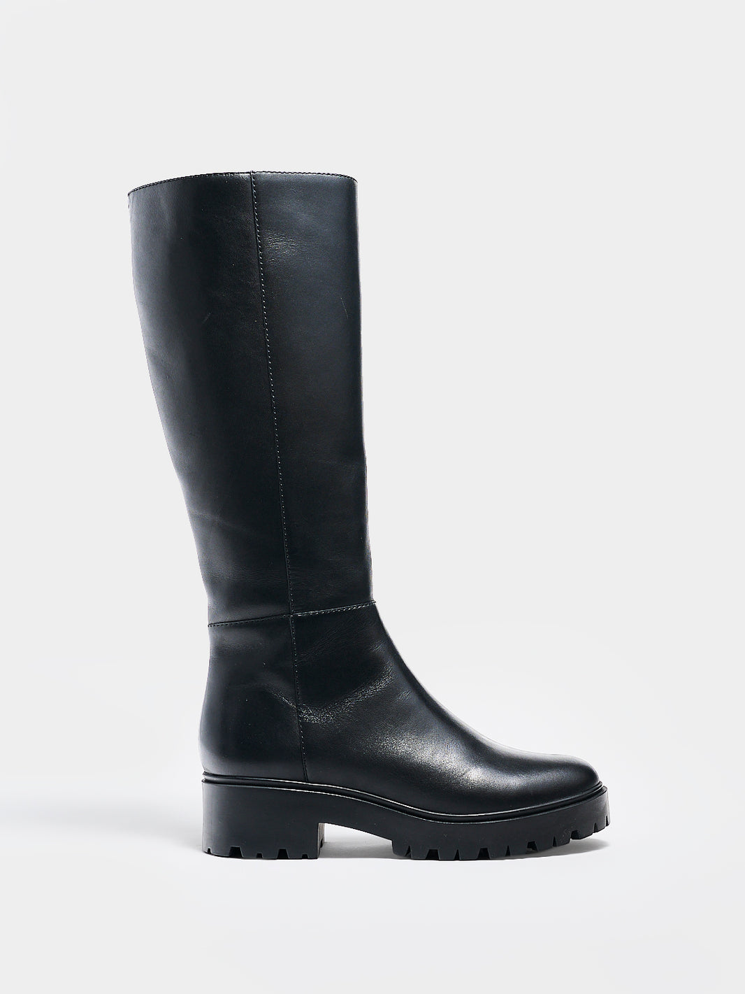 Profile view of a black nappa leather tall boot with a lug sole, zipper closure, and round toe. 