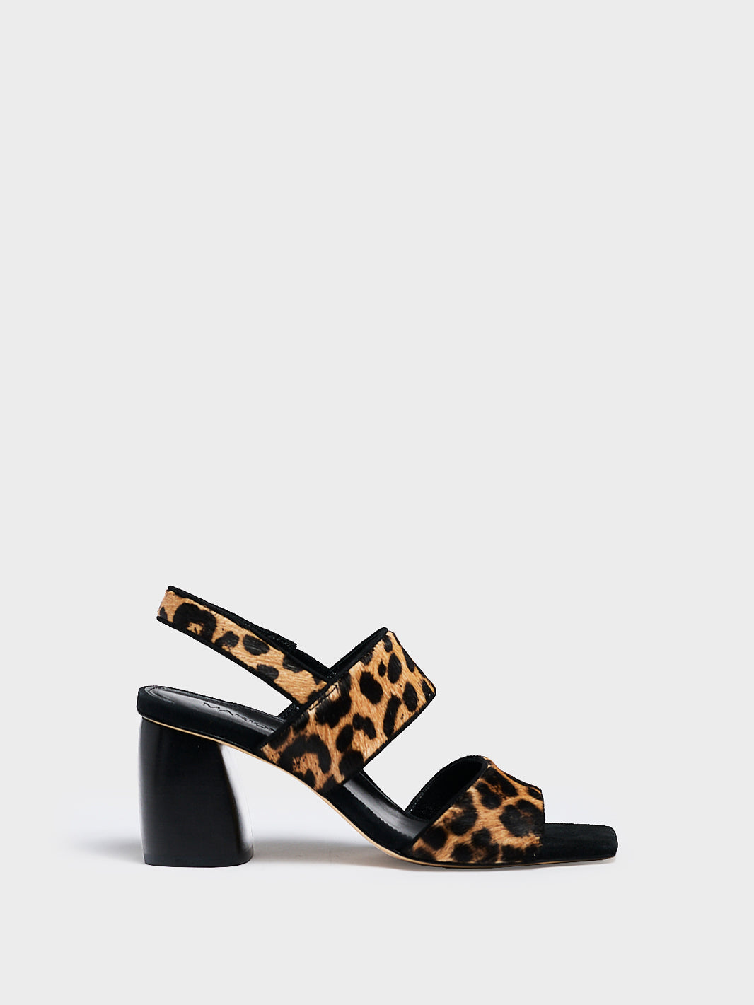 Profile view of a leopard print hair calf  block heel sandal with two over the foot straps and a square toe. 