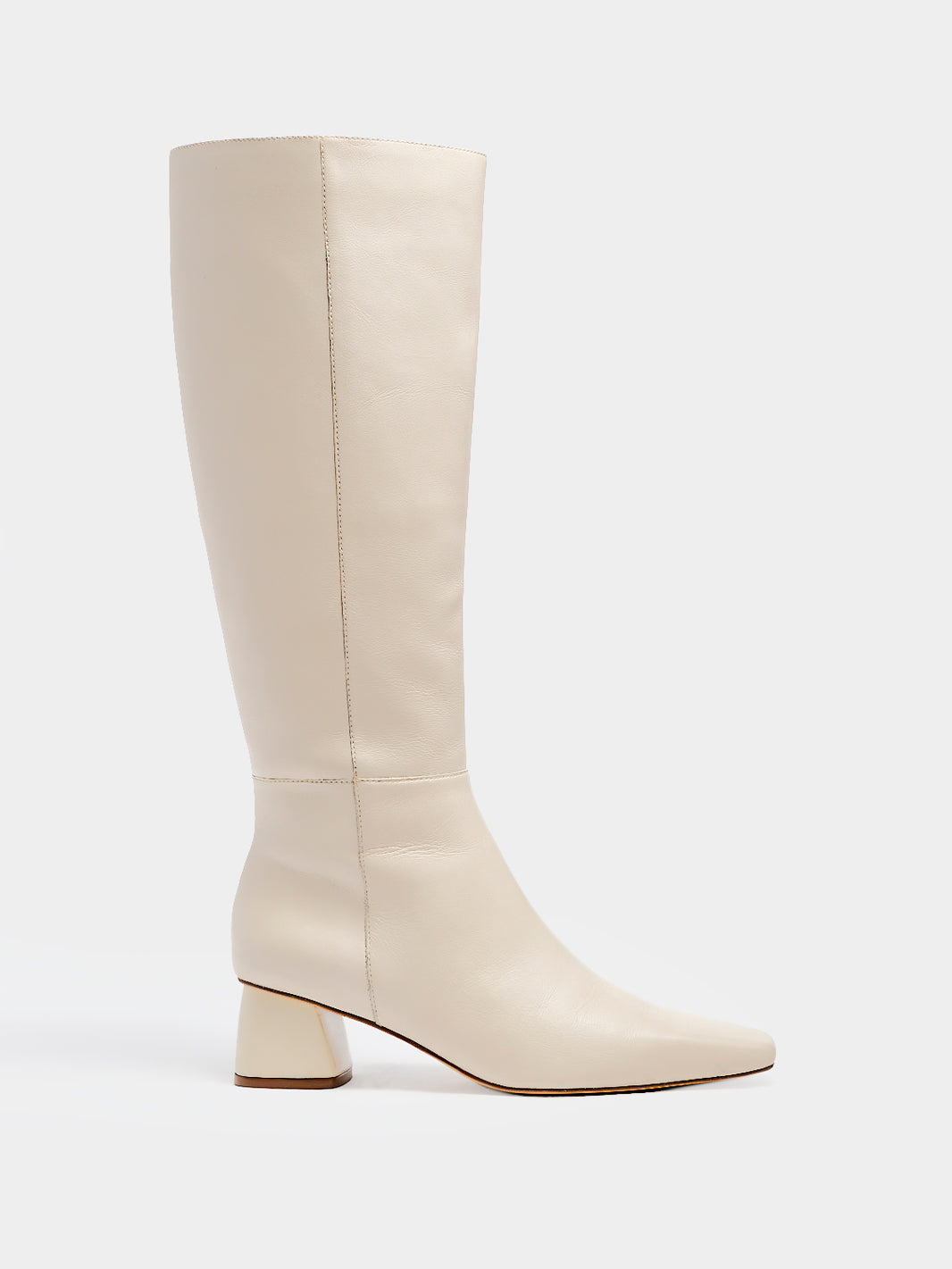 Profile view of a ivory nappa leather below the knee tall boot with a rounded heel shape, zipper closure, and square toe. 