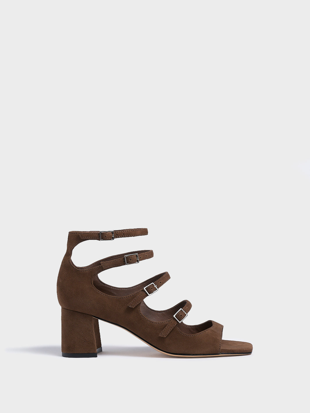 Profile view of a mocha brown suede block heel mary jane sandal with adjustable straps and a square toe. 