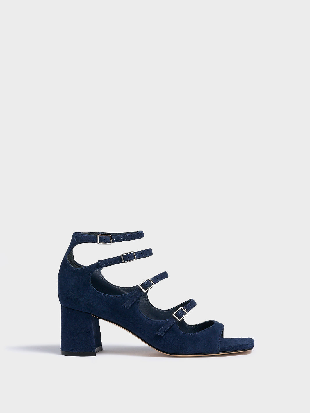 Profile view of a navy blue suede block heel mary jane sandal with adjustable straps and a square toe. 