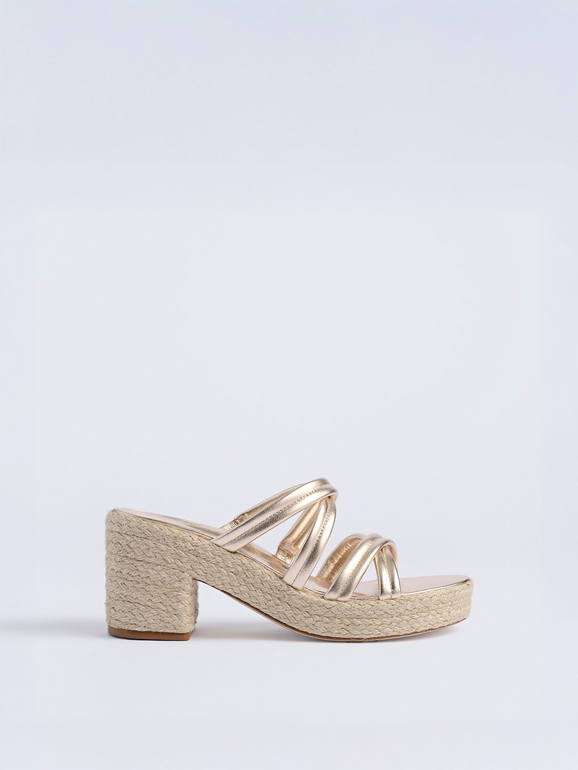Profile view of a gold metallic leather platform  sandal with a rounded toe