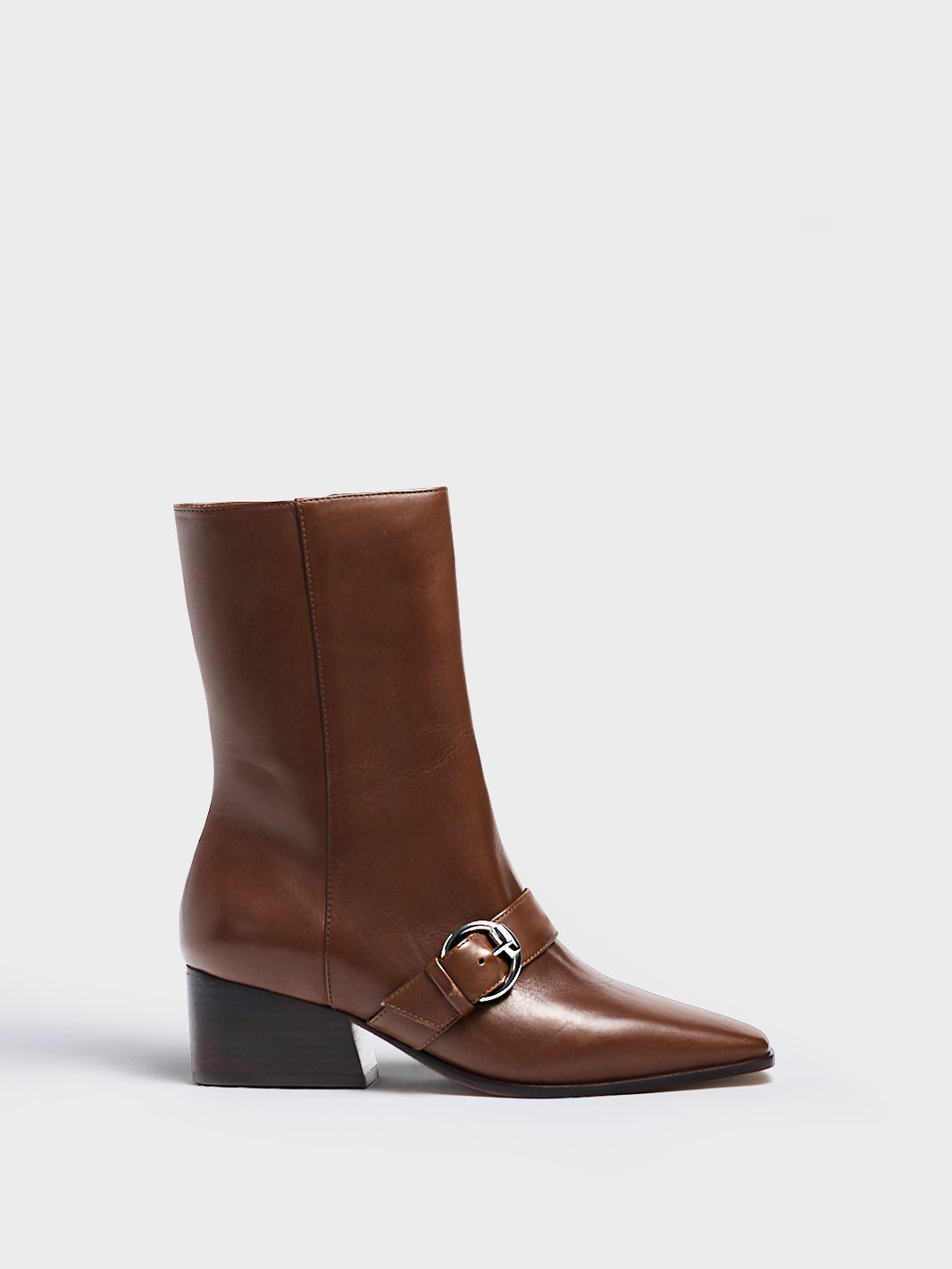 Profile view of a mocha brown nappa leather ankle bootie with a zipper closure, silver buckle, and block heel. 