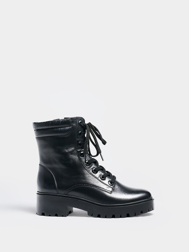 Profile view of a black nappa leather lace-up boot with a lug sole, zipper closure, and round toe. 