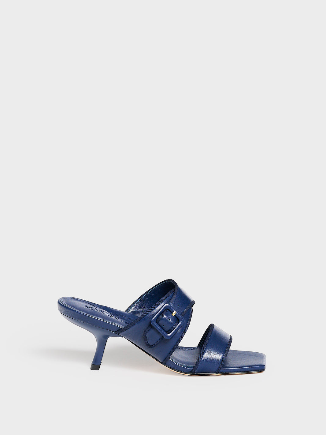 Profile view of a navy leather slide kitten heel sandal with a buckle detail.