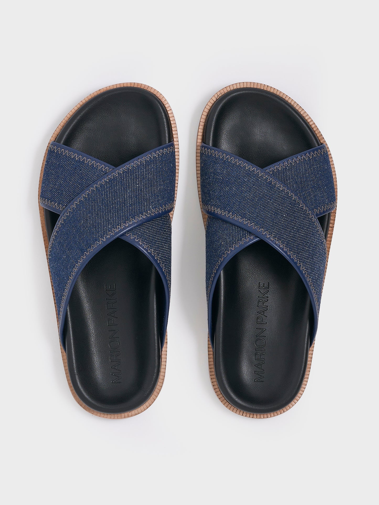 Top view of a pair of navy denim molded footbed slide sandals.