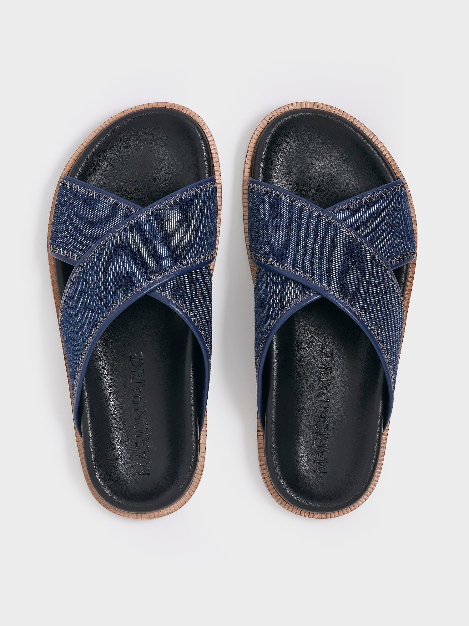 Top view of a pair of navy denim molded footbed slide sandals.