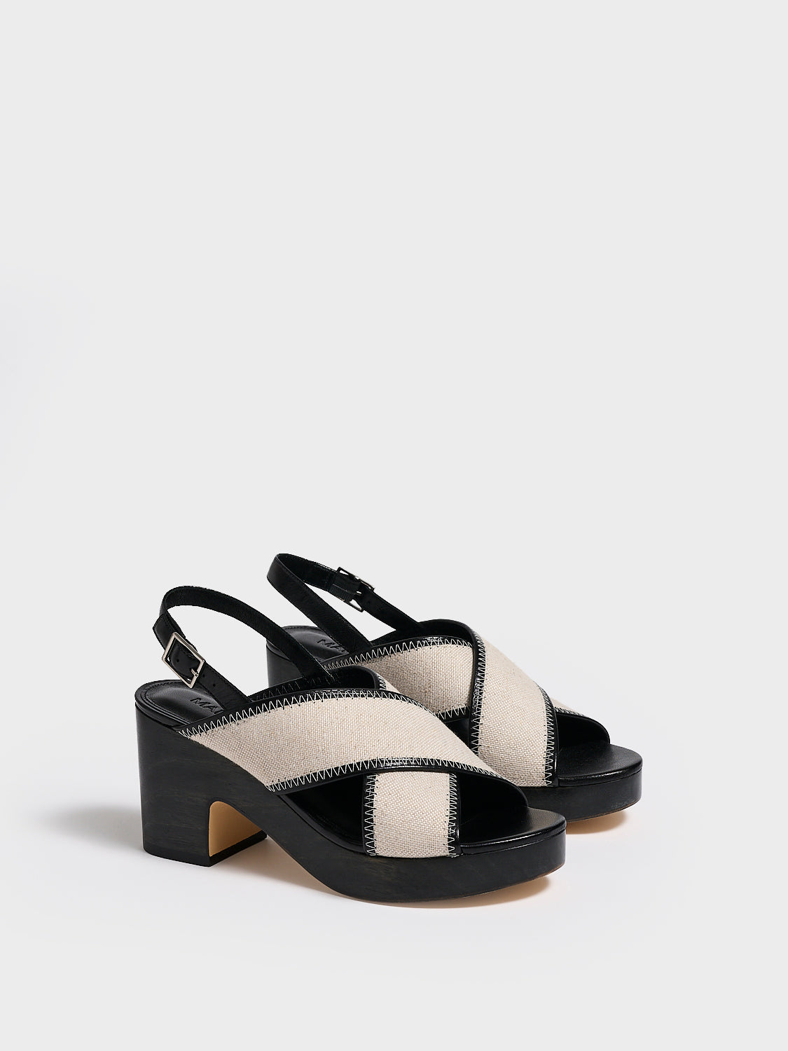 Angle view of a pair of salt and pepper linen platform sandals with an adjustable back strap.
