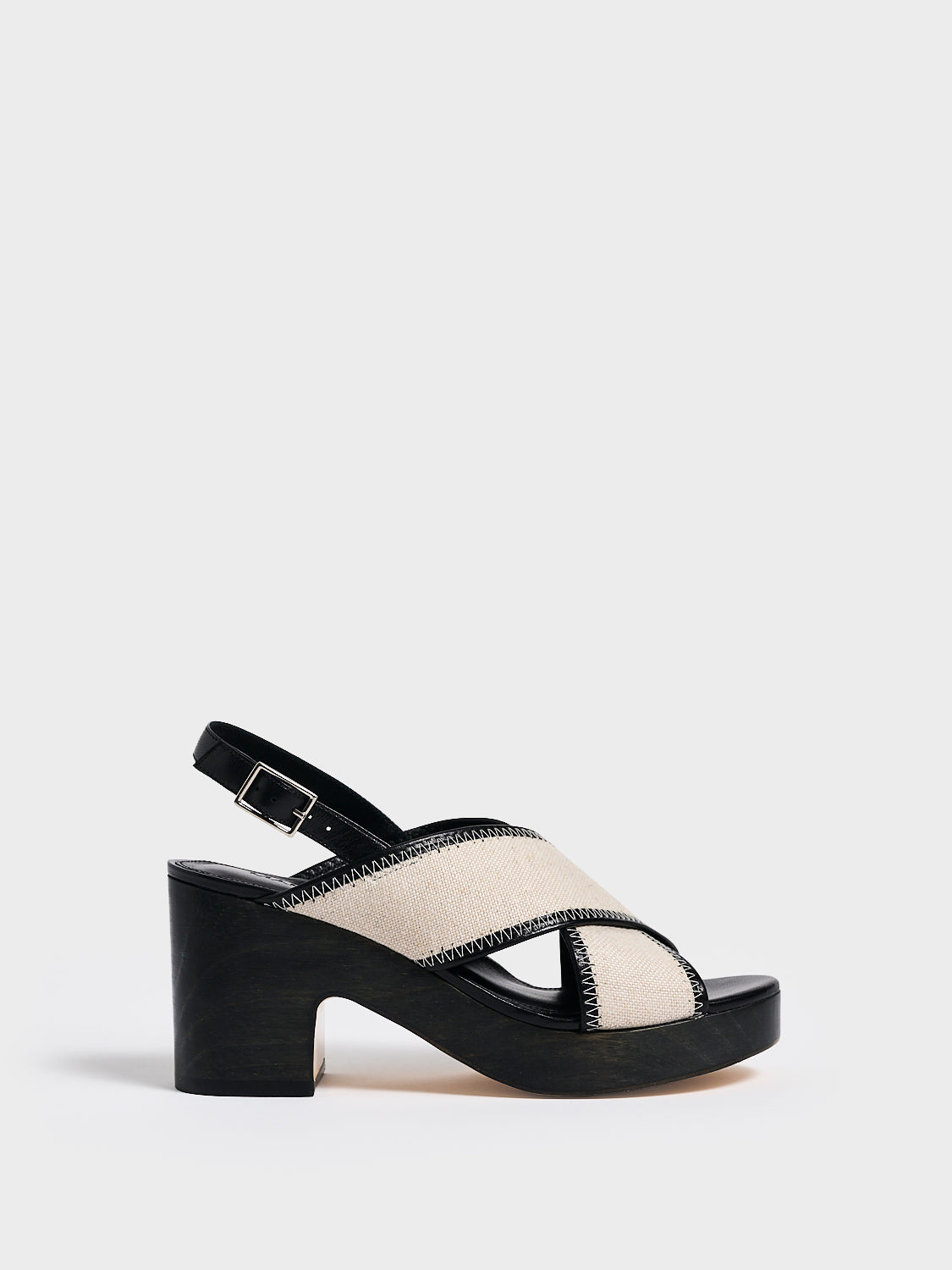 Profile view of a salt and pepper linen platform sandal with an adjustable back strap.