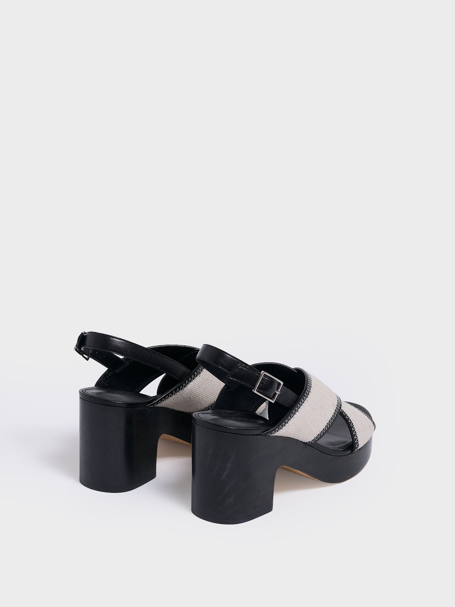 Back view of a pair of salt and pepper linen platform sandals with an adjustable back strap.