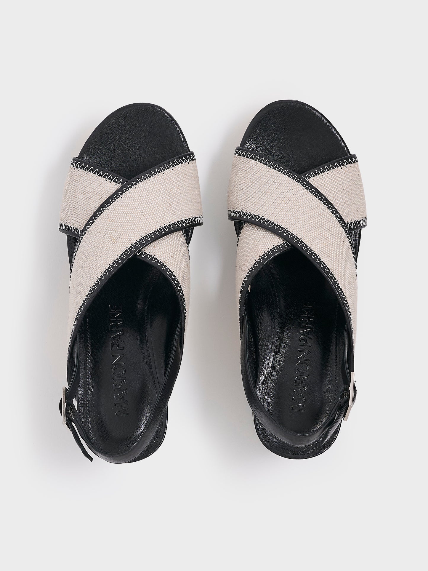 Top view of a pair of salt and pepper linen platform sandals with an adjustable back strap.