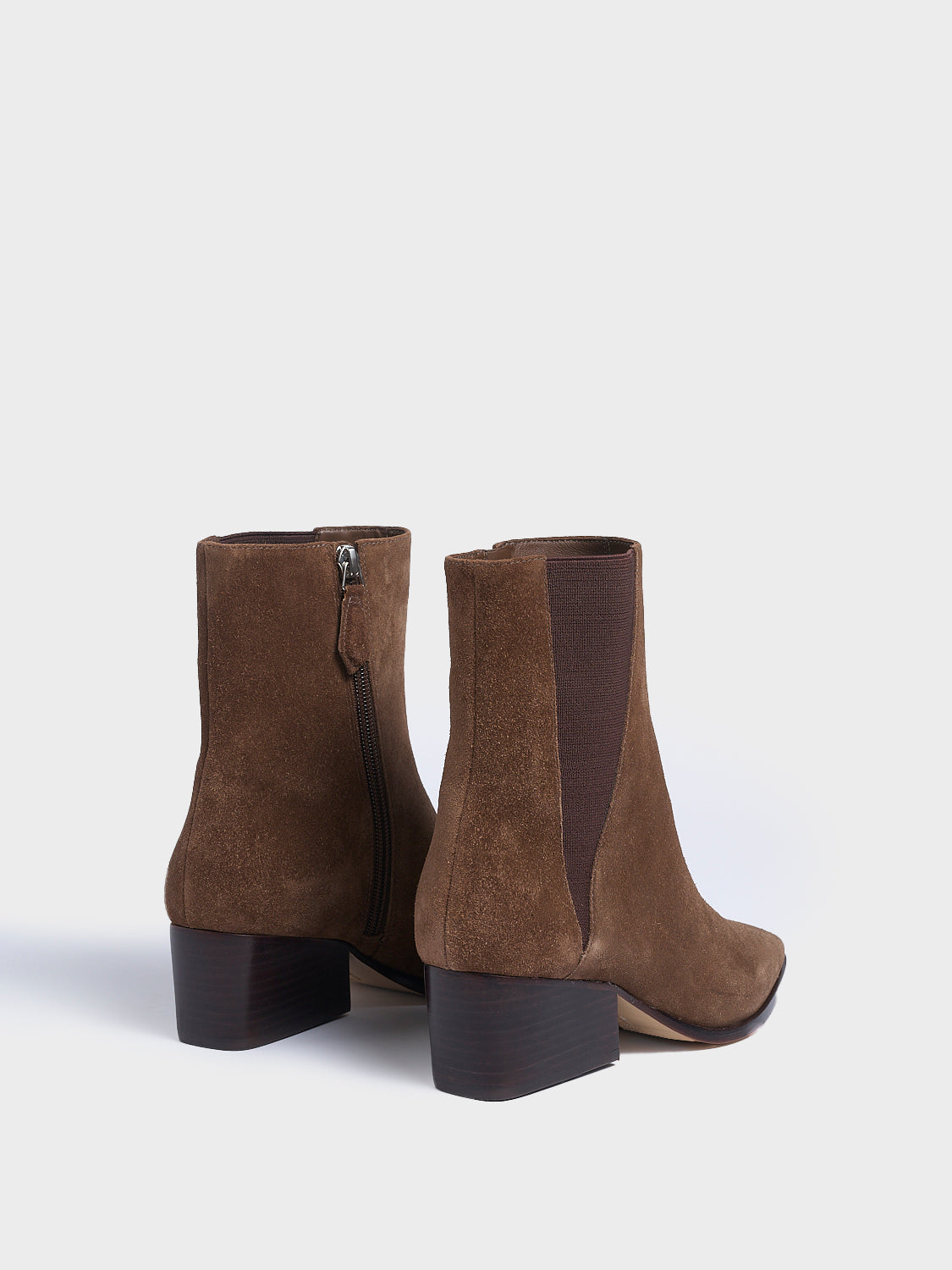 Back view of a pair of mocha brown suede chelsea ankle bootie with a zipper closure, square toe, and block heel. 