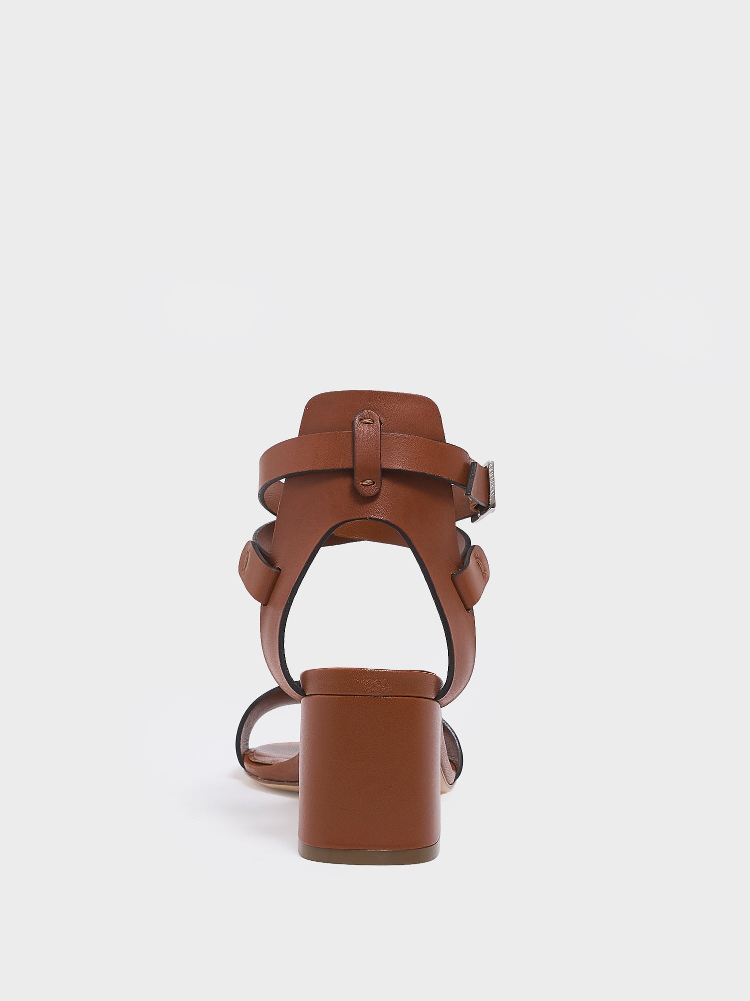 Back view of a chestnut leather block heel sandal with an adjustable ankle strap design.
