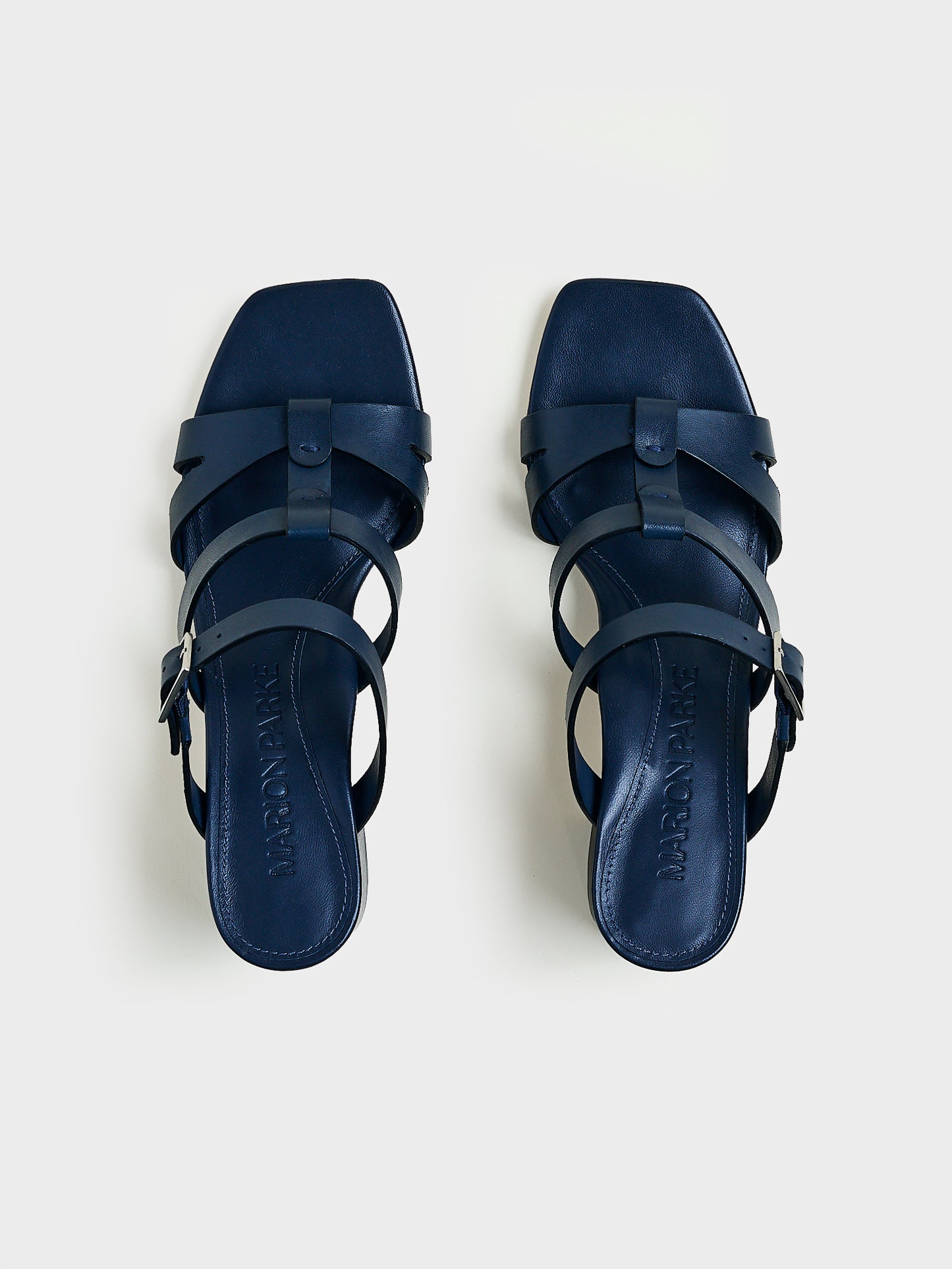 Top view of a pair of navy nappa leather gladiator block heel sandals.