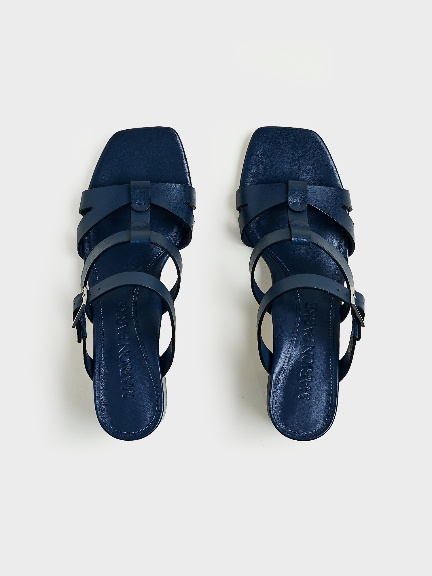 Top view of a pair of navy nappa leather gladiator block heel sandals.