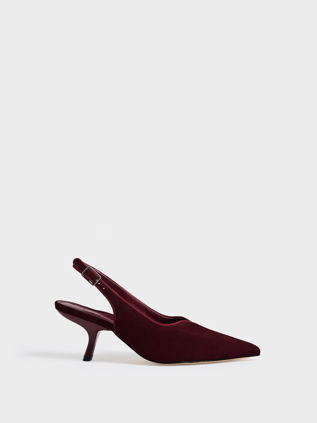 Profile view of a burgundy  leather slingback kitten heel with a grosgrain trim and angled heel detail.
