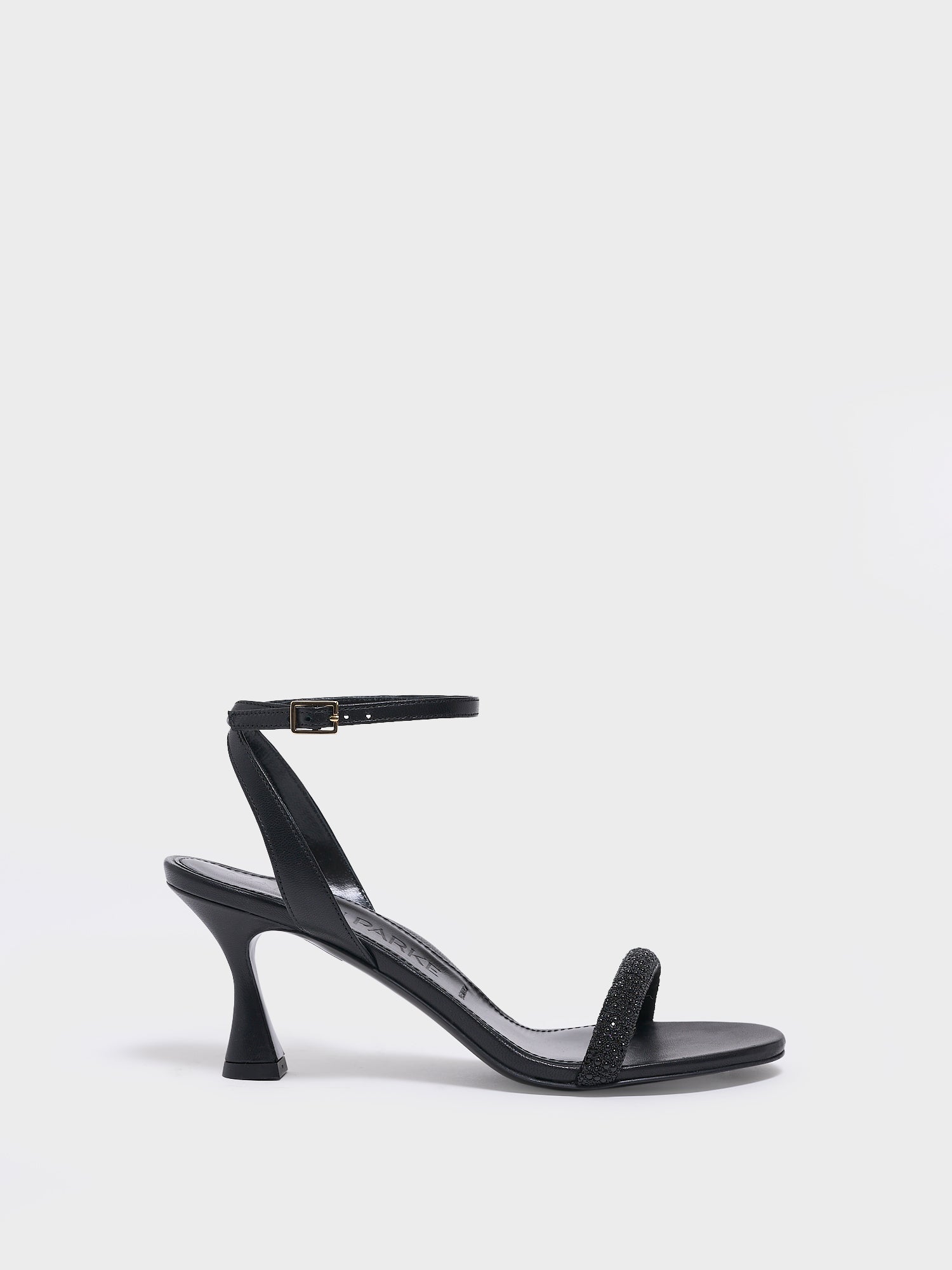 Profile view of an black leather high heel sandal with a crystal embellished toe strap and adjustable ankle strap.