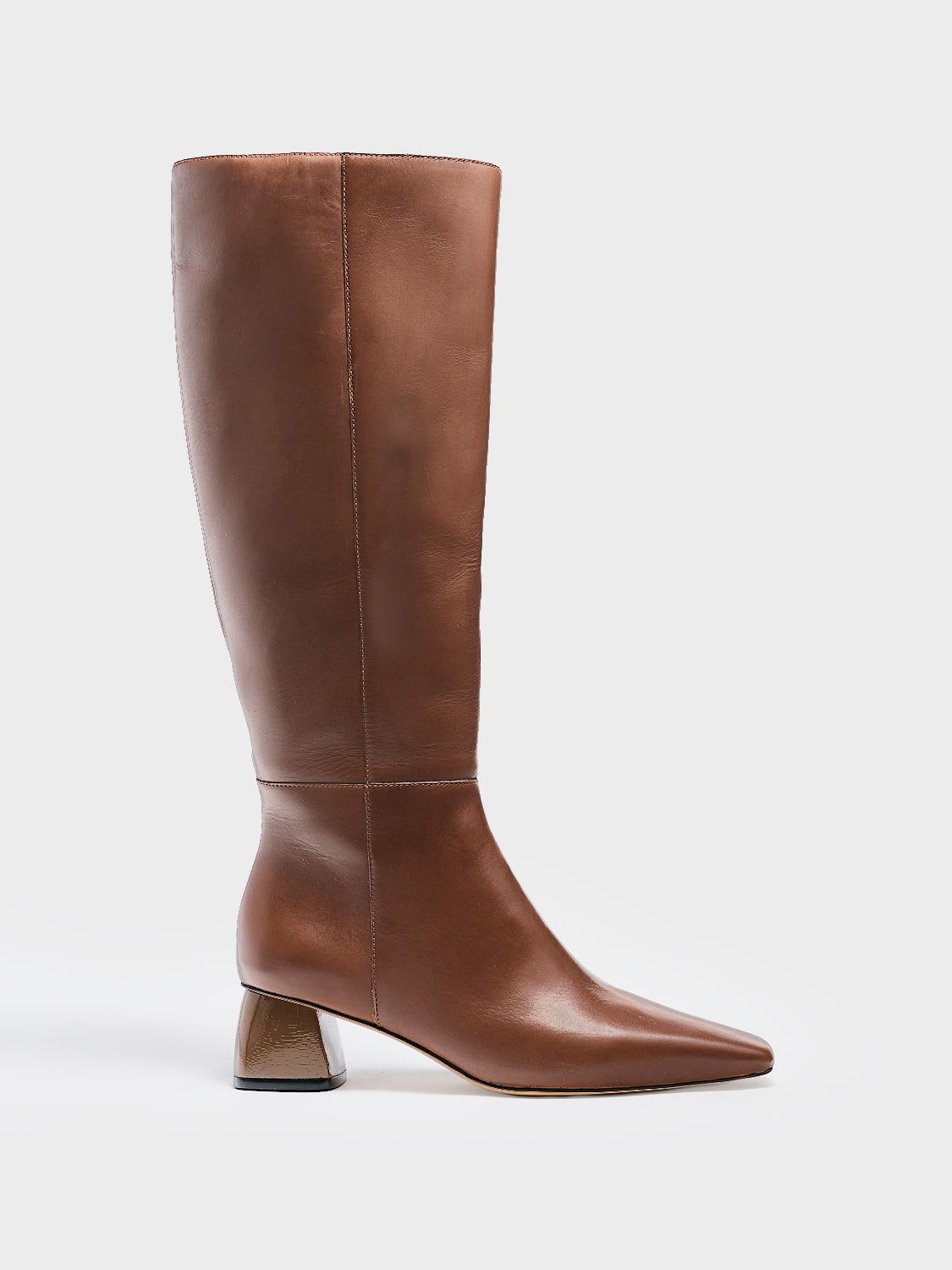 Profile view of a mocha brown nappa leather below the knee tall boot with a rounded heel shape, zipper closure, and square toe. 