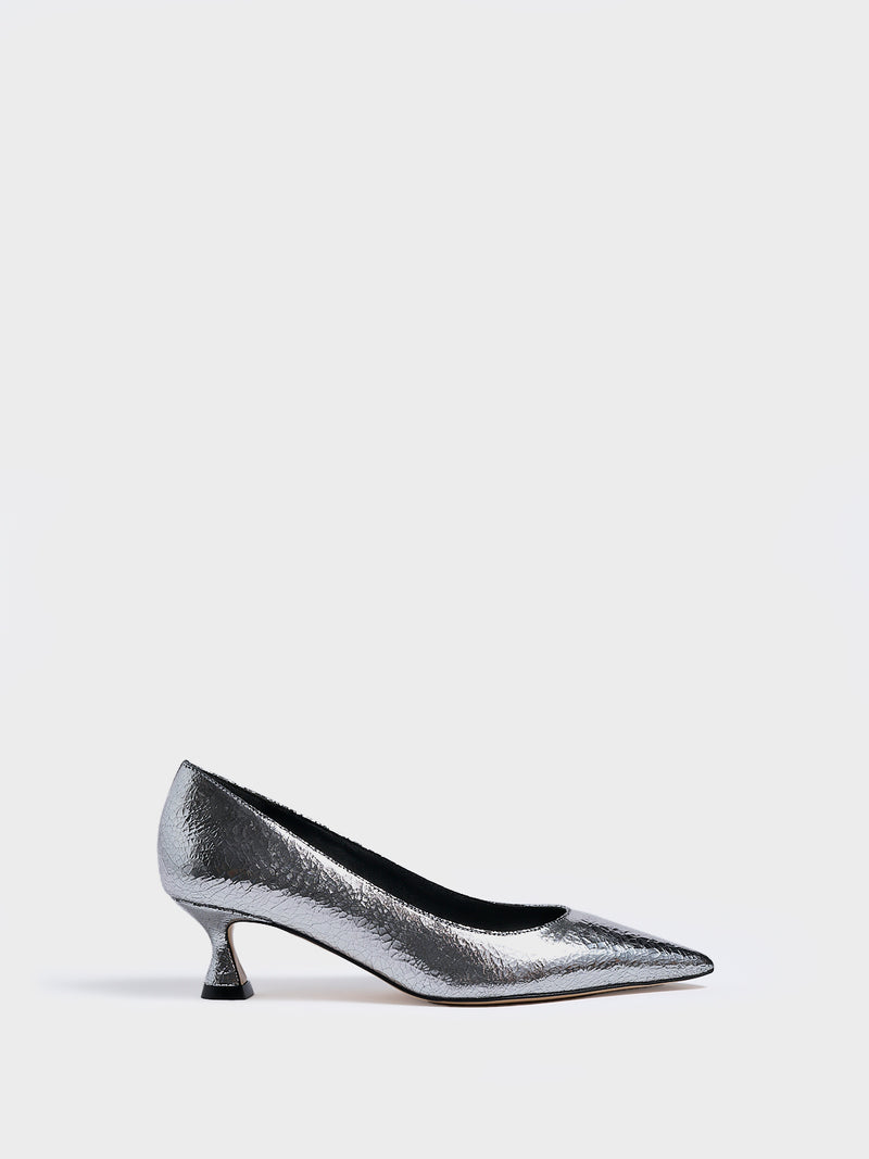 Profile view of a silver metallic leather flared kitten heel pump with a pointed toe.