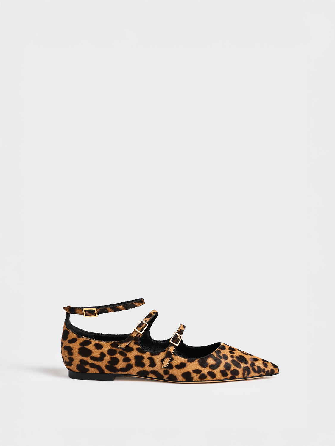 Profile view of a leopard hair calf mary jane flat with adjustable straps and a pointed toe. 