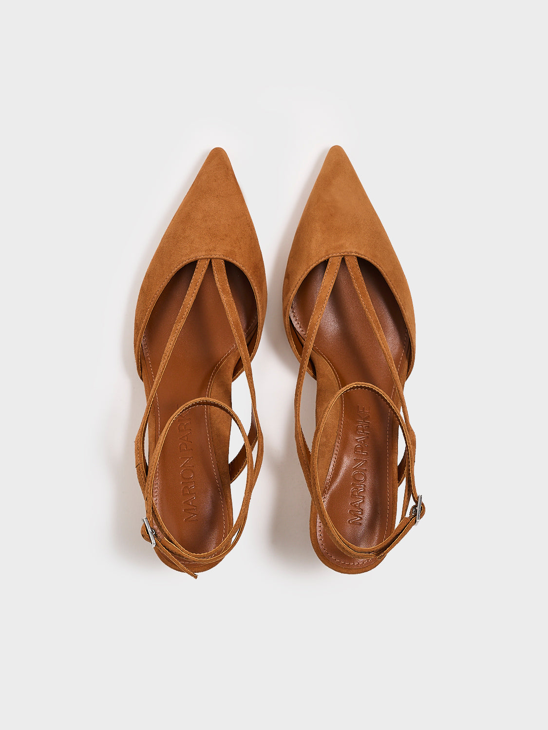 Top view of a pair of chestnut suede kitten heels with sculpted strap design and an adjustable ankle strap.