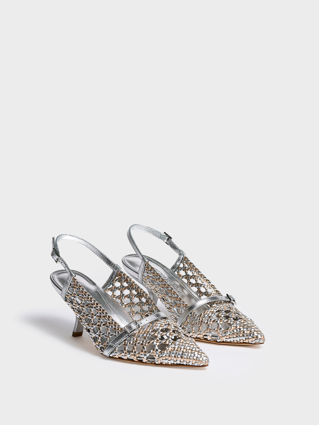 Angle view of a pair of silver and gold metallic braided leather kitten heel with a slingback detail.