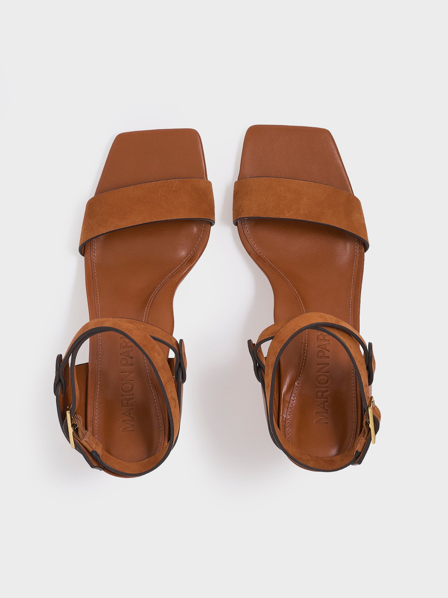 Top view of a pair of chestnut leather and suede high heel sandals with a sculptural design and adjustable ankle strap. 